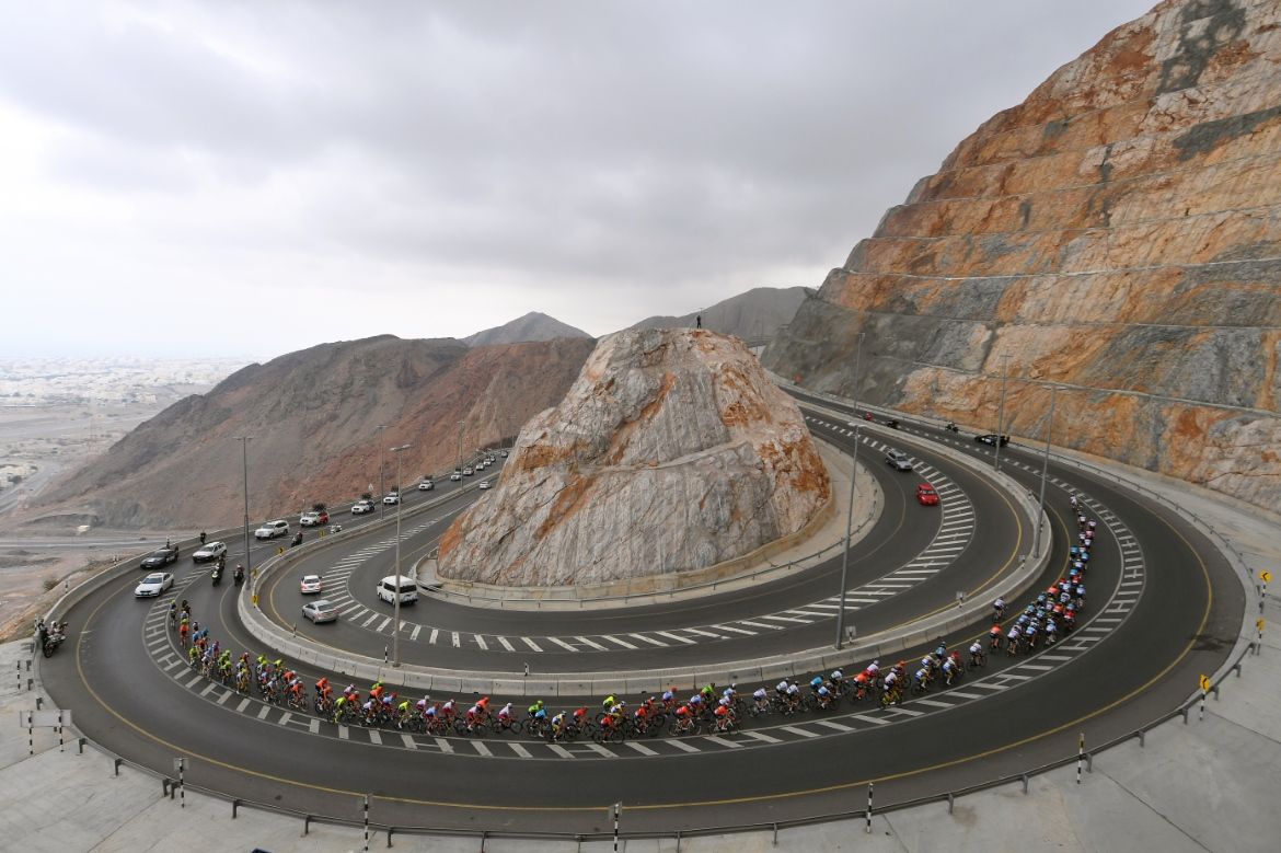 The peloton strung out on a climb