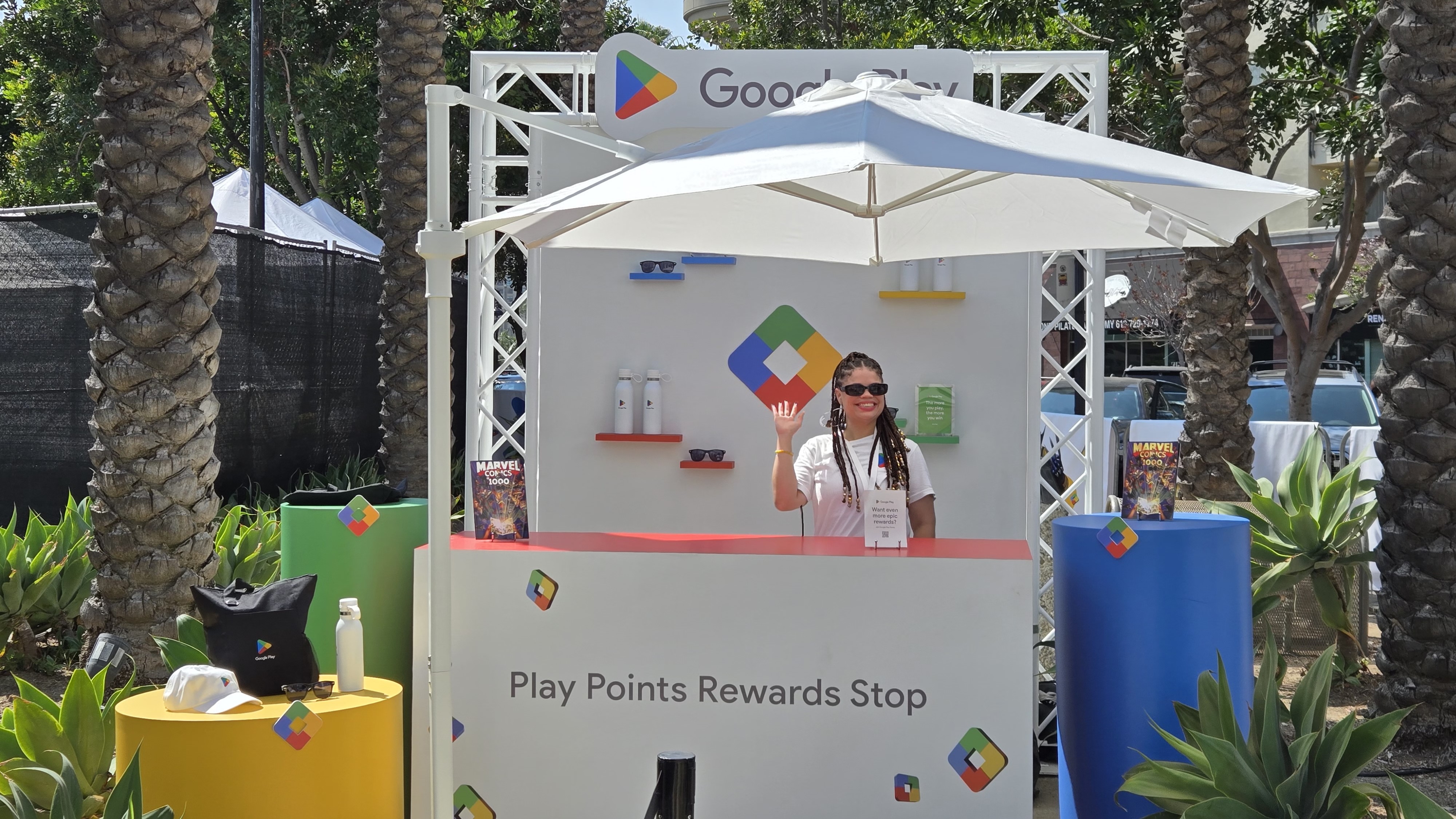 A woman waving at the Google Play reward booth