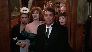 A still from the 1985 Clue movie, with Tim front and center smirking at someone off camera