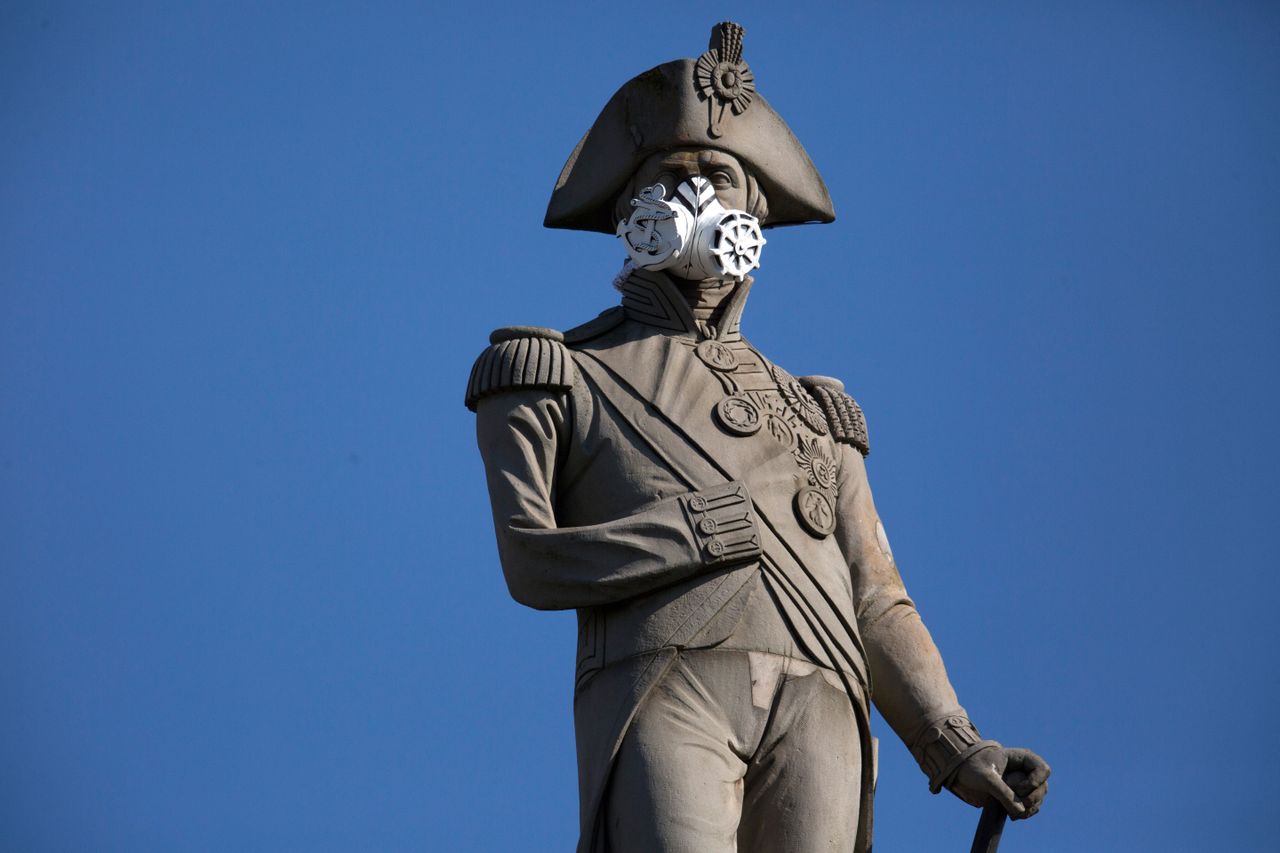 Nelson's Column in London wears a face mask as Greenpeace protesters highlight air pollution