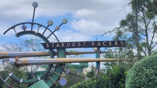 The green celestial sign outside of Stardust Racers at Universal Orlando.