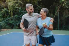 Senior couple playing pickleball