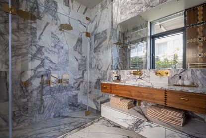 a marble and brass bathroom