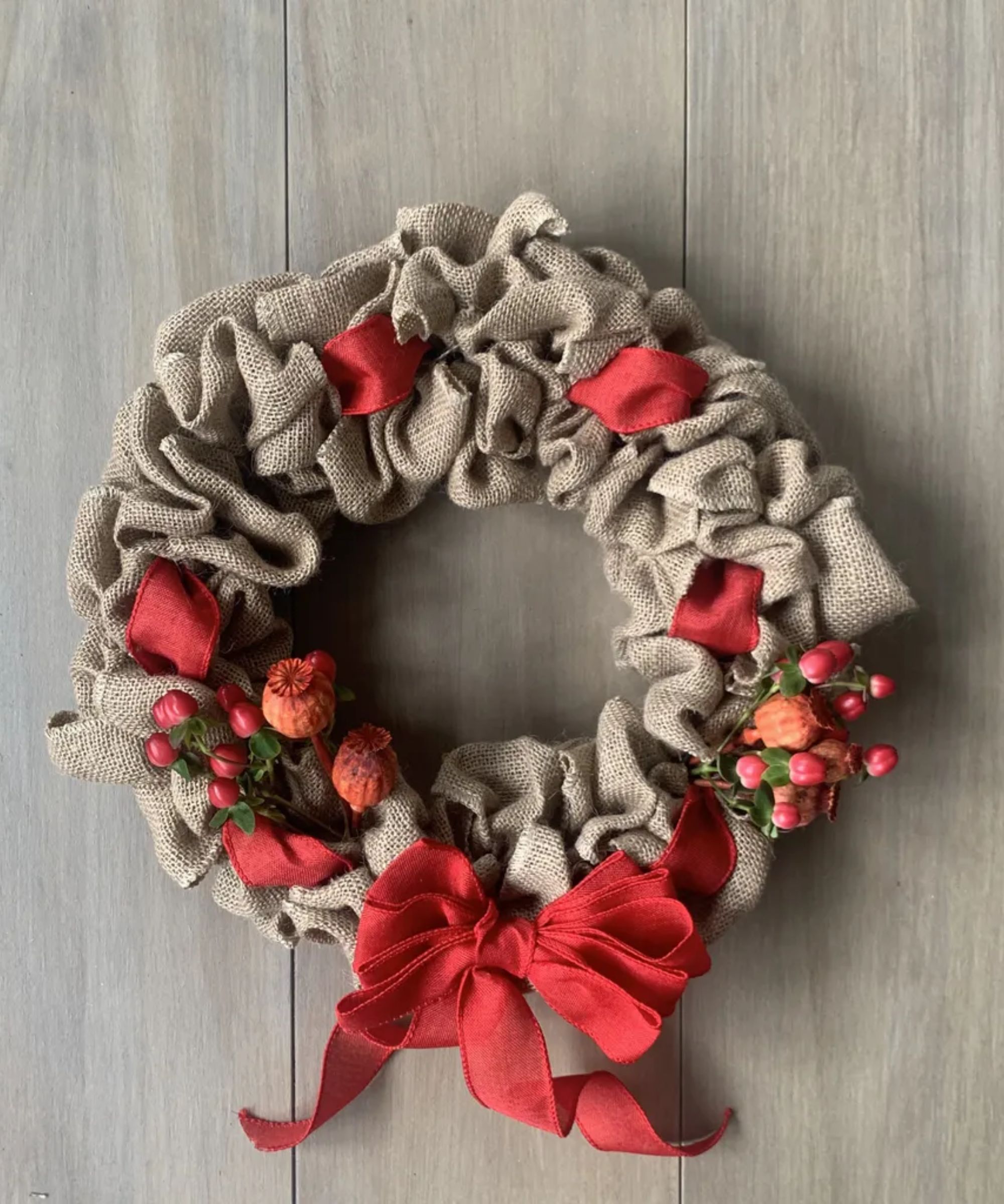 Burlap wreath with red berries and a bow