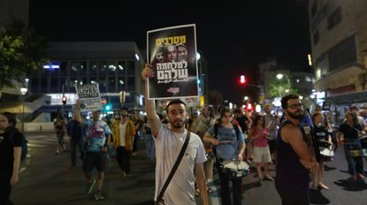 JERUSALEM - MAY 17: Hundreds of Israelis stage a demonstration at Paris Square, demanding the continuation of the hostage swap, the return of Israeli hostages, and a ceasefire in Gaza, on May 17, 2025, in West Jerusalem. The protestors marched and chanted anti-government slogans chanted slogans against Prime Minister Benjamin Netanyahu and members of his government, holding photographs of Israeli hostages and Israeli flags. 
