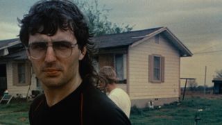 David Koresh standing in front of a house in Waco: American Apocalypse