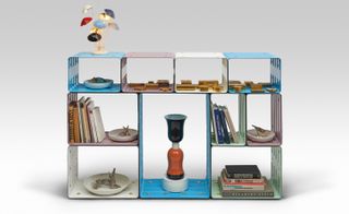 Brightly coloured shelving unit with a lamp on top