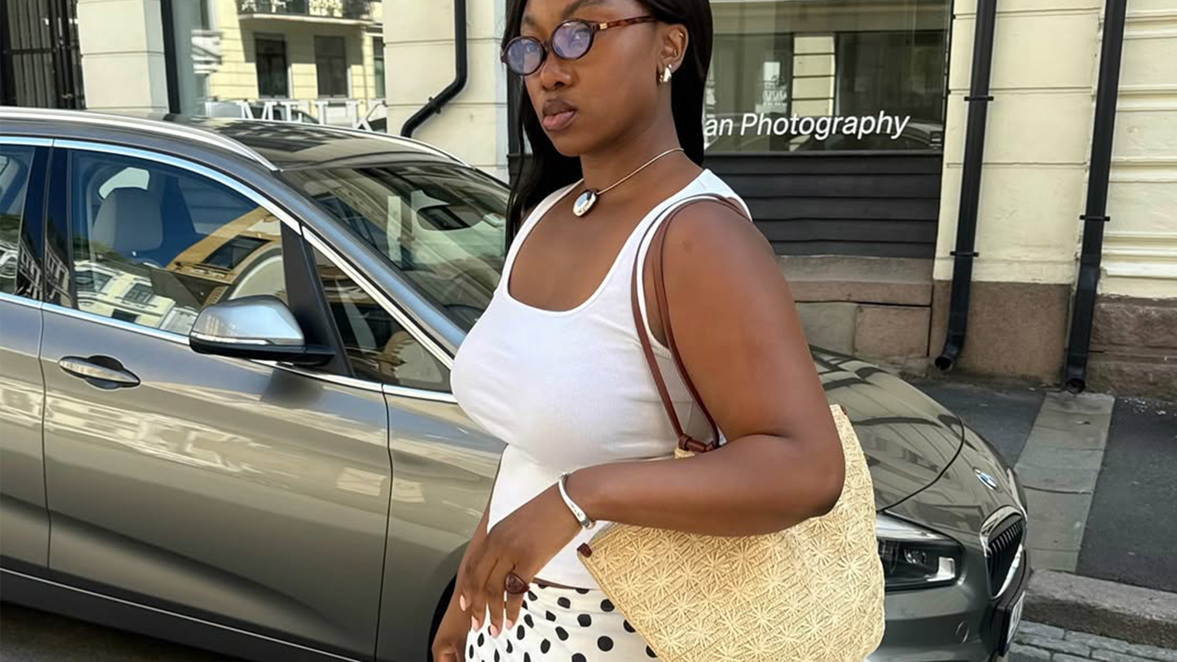 Nnenna Echem wearing a polka dot skirt with a white tank top.