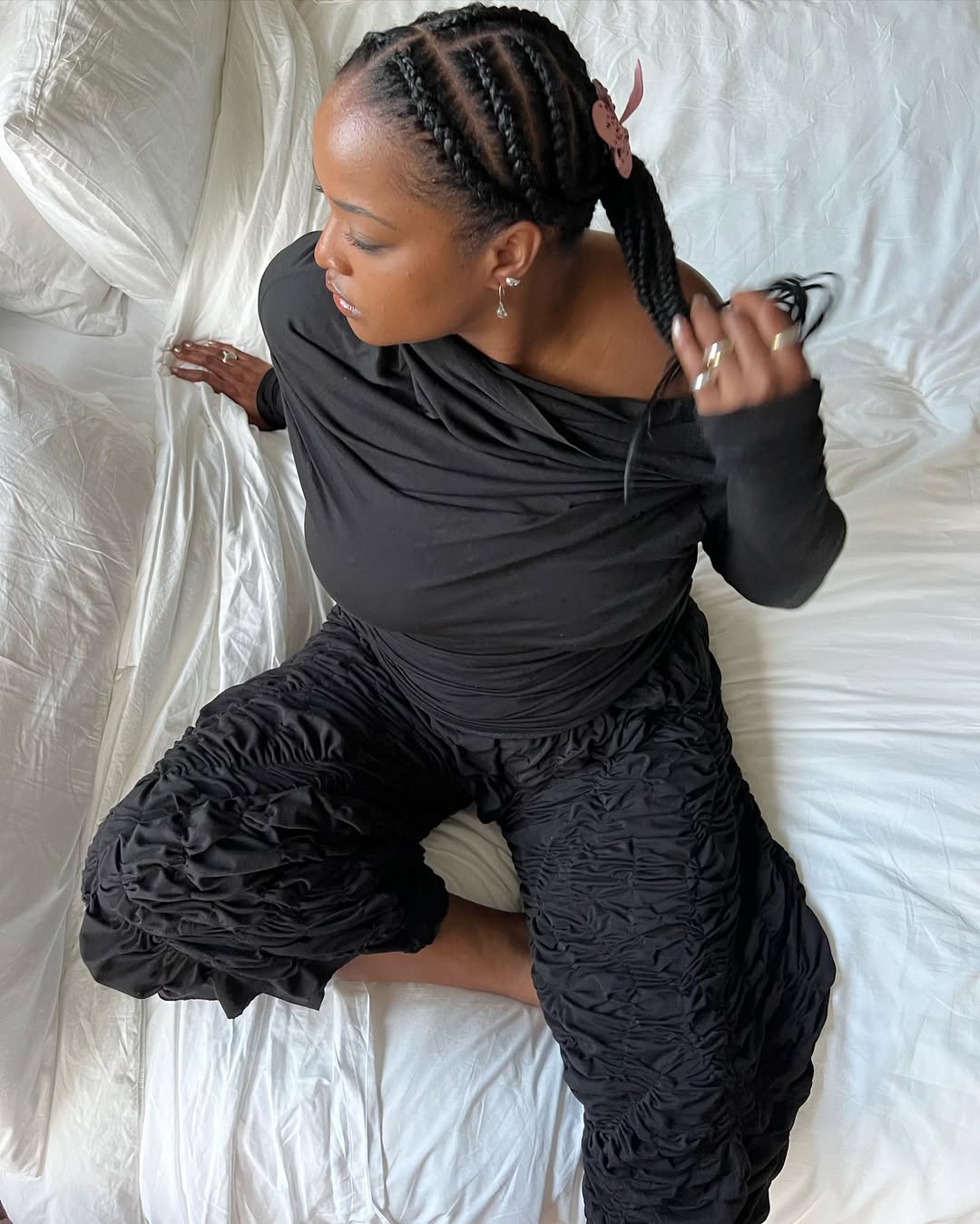 Imani Randolph wears cornrows with a pink bow