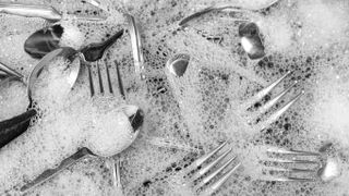 Silver cutlery in soapy water