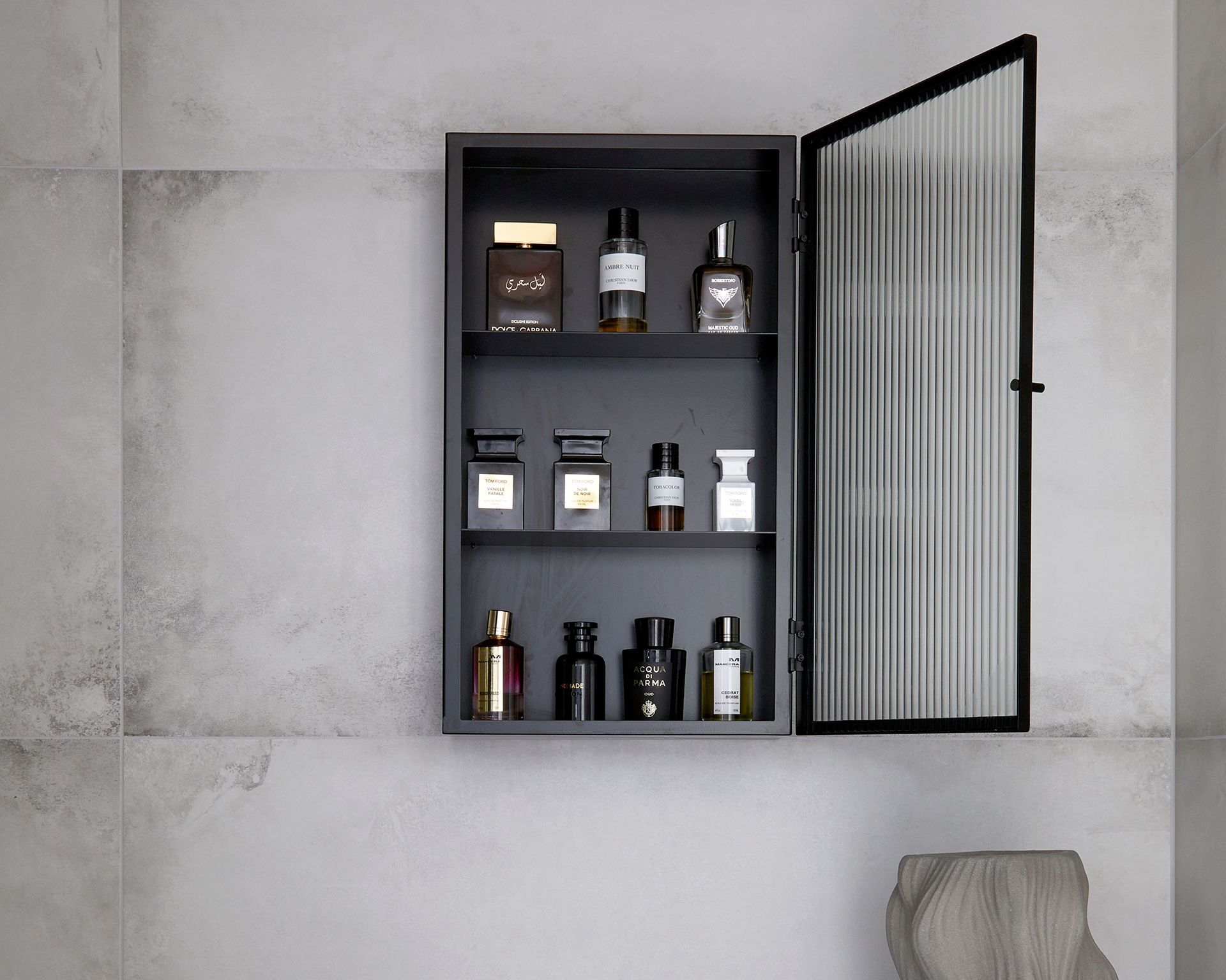 Medicine cabinet organization in black cabinet against gray wall