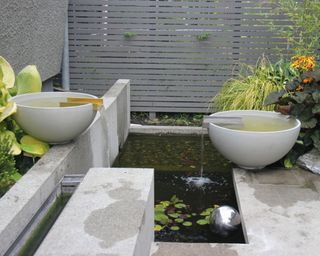 A double bown water feature in a modern backyard
