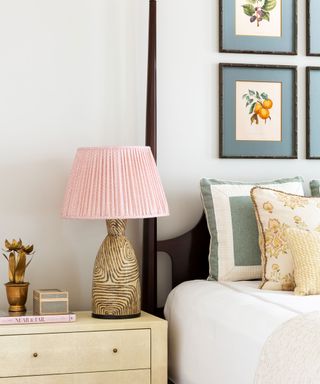 Close up of colorful bedside table lamp bedside poster bed, blue artwork above bed