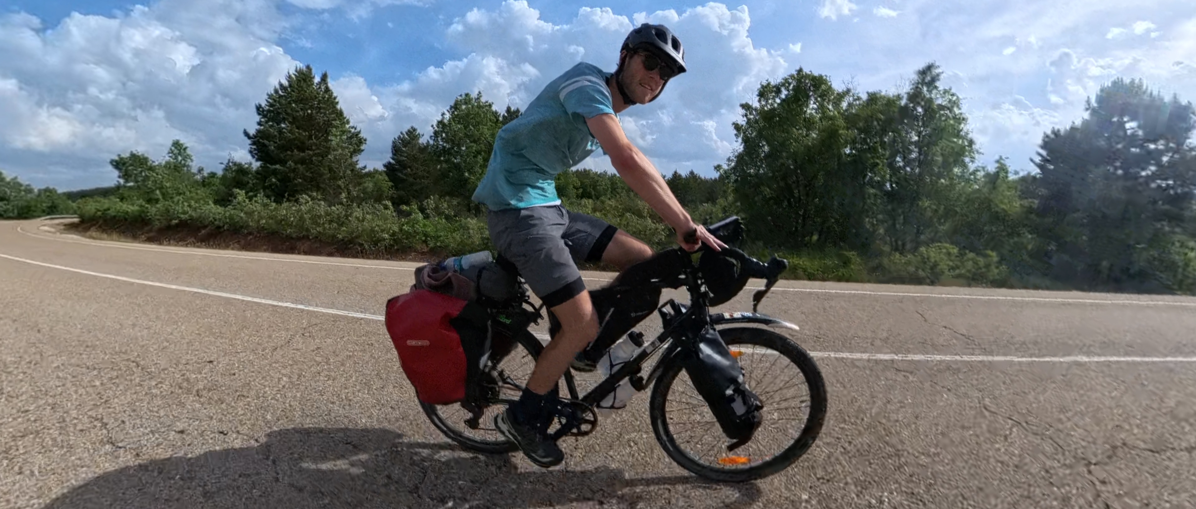 Man cycles on a bike on a road