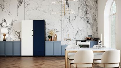 a samsung navy and white fridge freezer in a kitchen with marble effect wallpaper and brass lighting