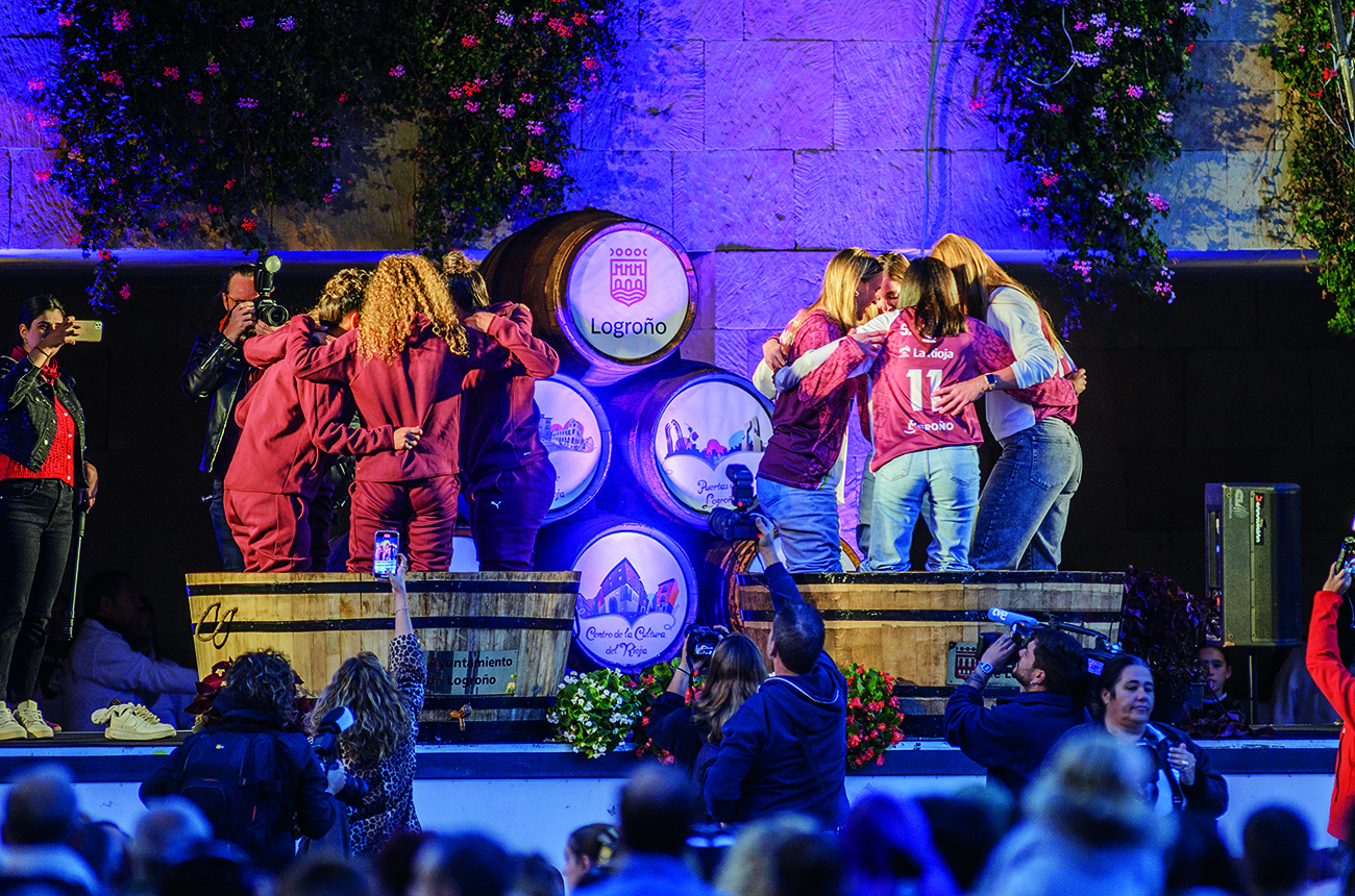 six people on a stage celebrating Fiestas de San Mateo