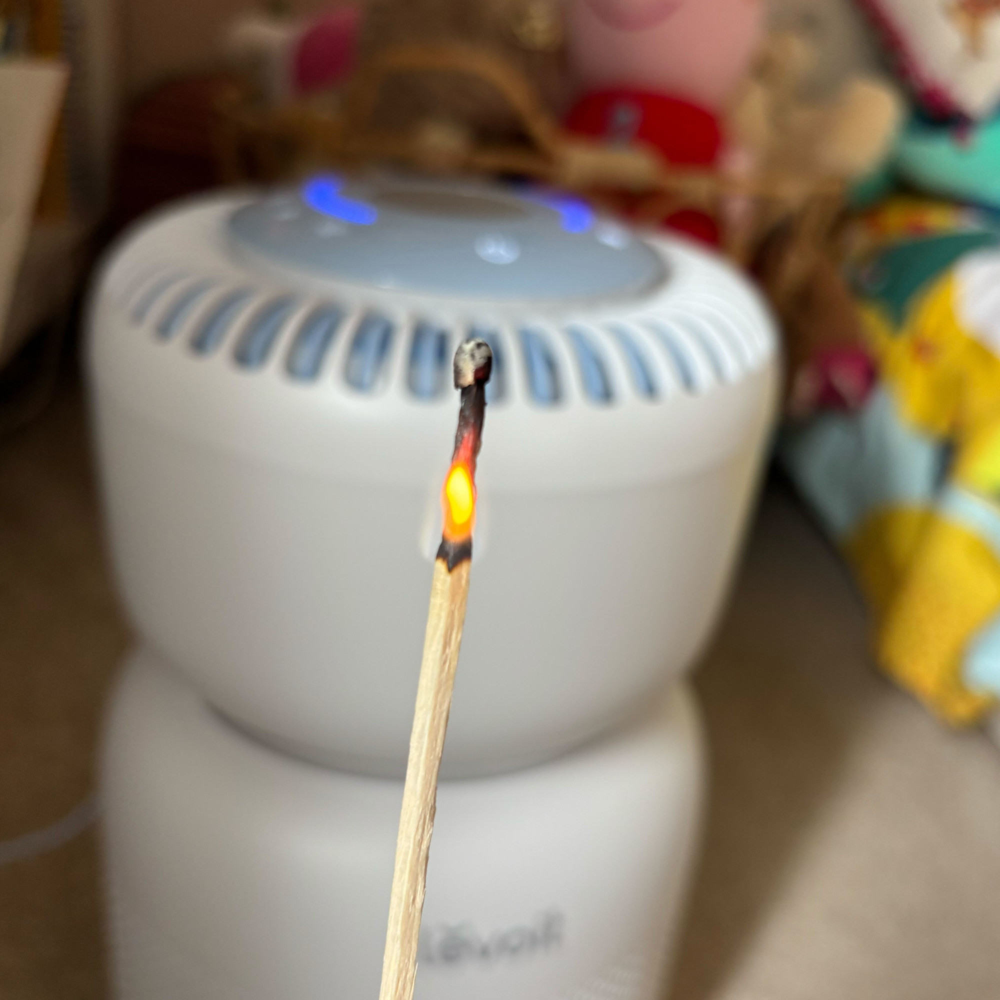 a lit match near the levoit sprout air purifier