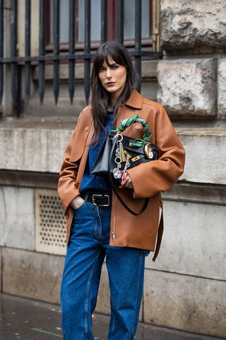 Woman wearing a denim shirt outfit.