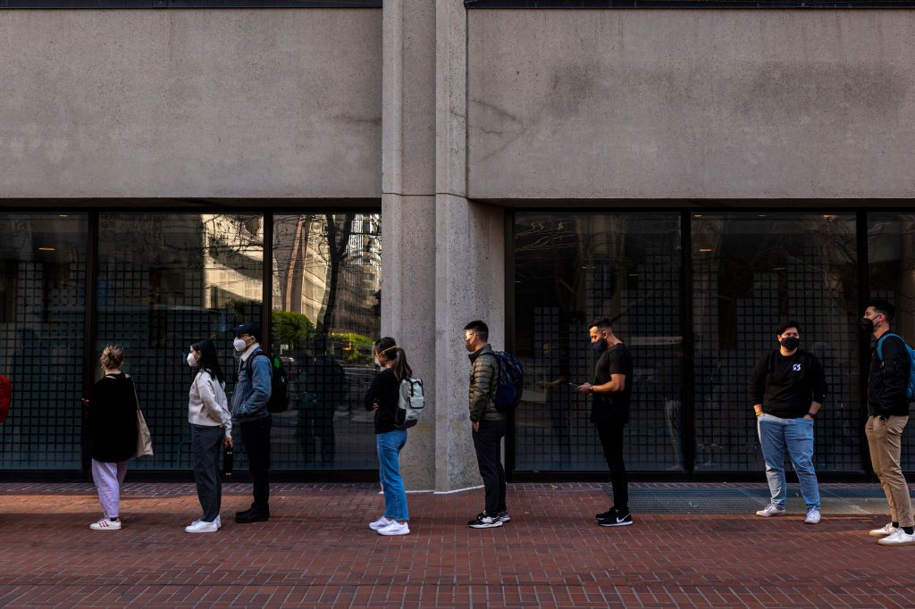 Americans wait in line for COVID testing.