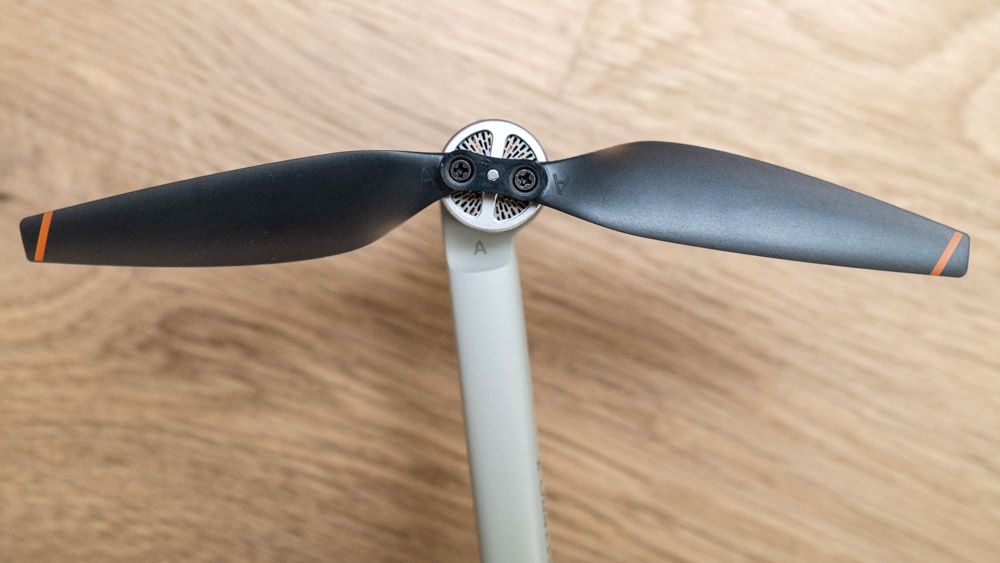 Close up of a propellor on a Ruko F11PRO 2 drone on a wooden surface