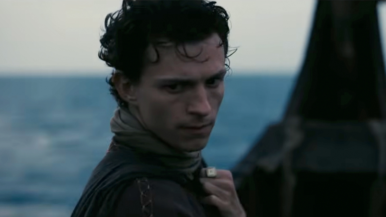 Tom Holland on a ship at sea, looking serious, in The Odyssey