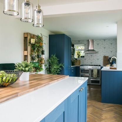 blue kitchen with island and bar stools