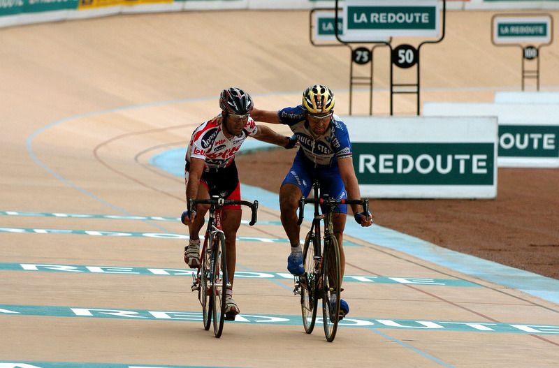 Peter Van Petegem and Johan Museeuw cross the line in 2004 arm in arm