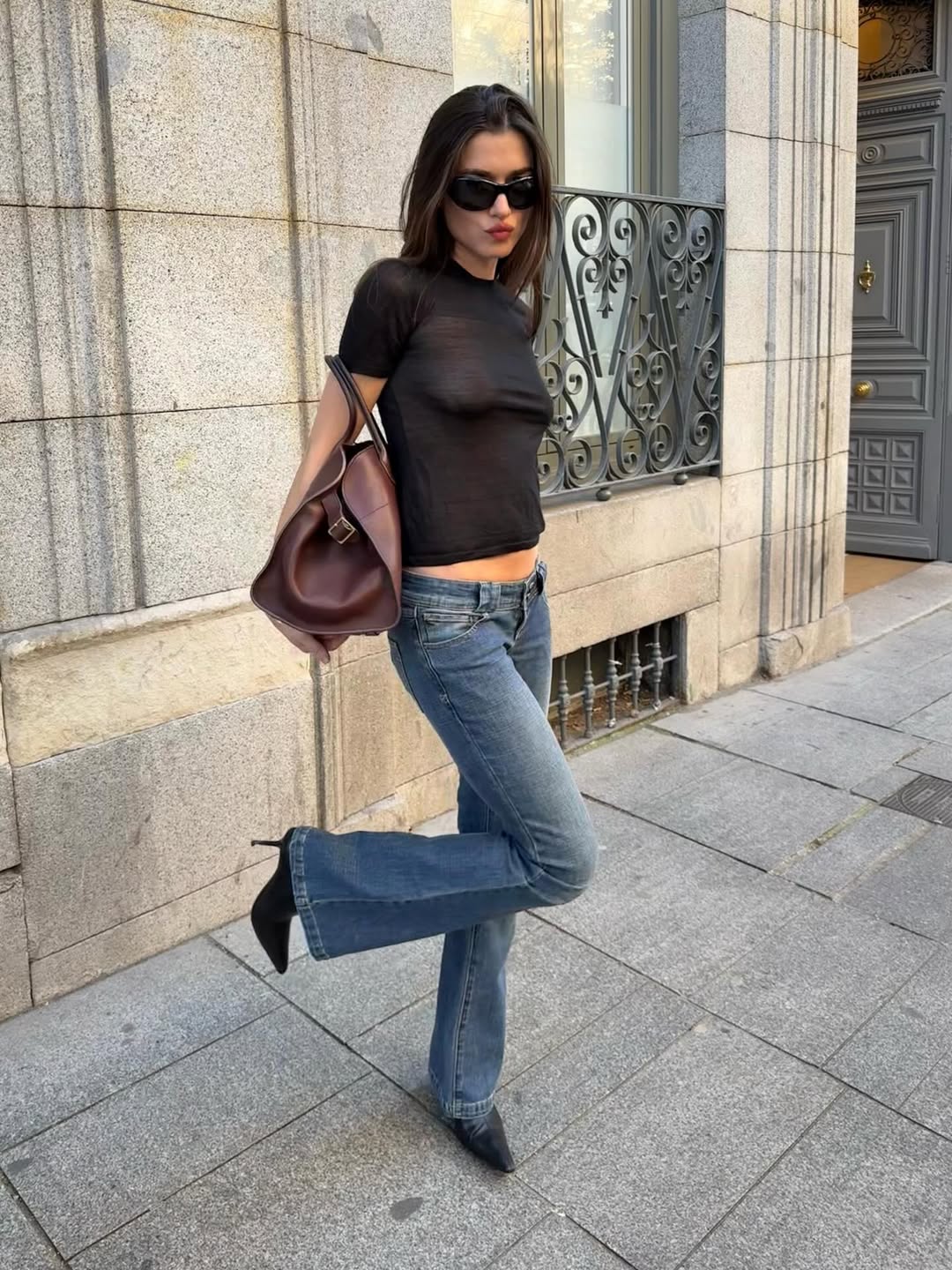 Ilirida in boot-cut jeans and black t-shirt