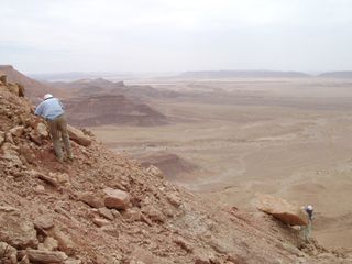 Paleontologists taking part in an expedition led by Nizar Ibrahim scour the Cretaceous rocks of the Kem Kem region of southeastern Morocco, where the partial skeleton of Spinosaurus was found.