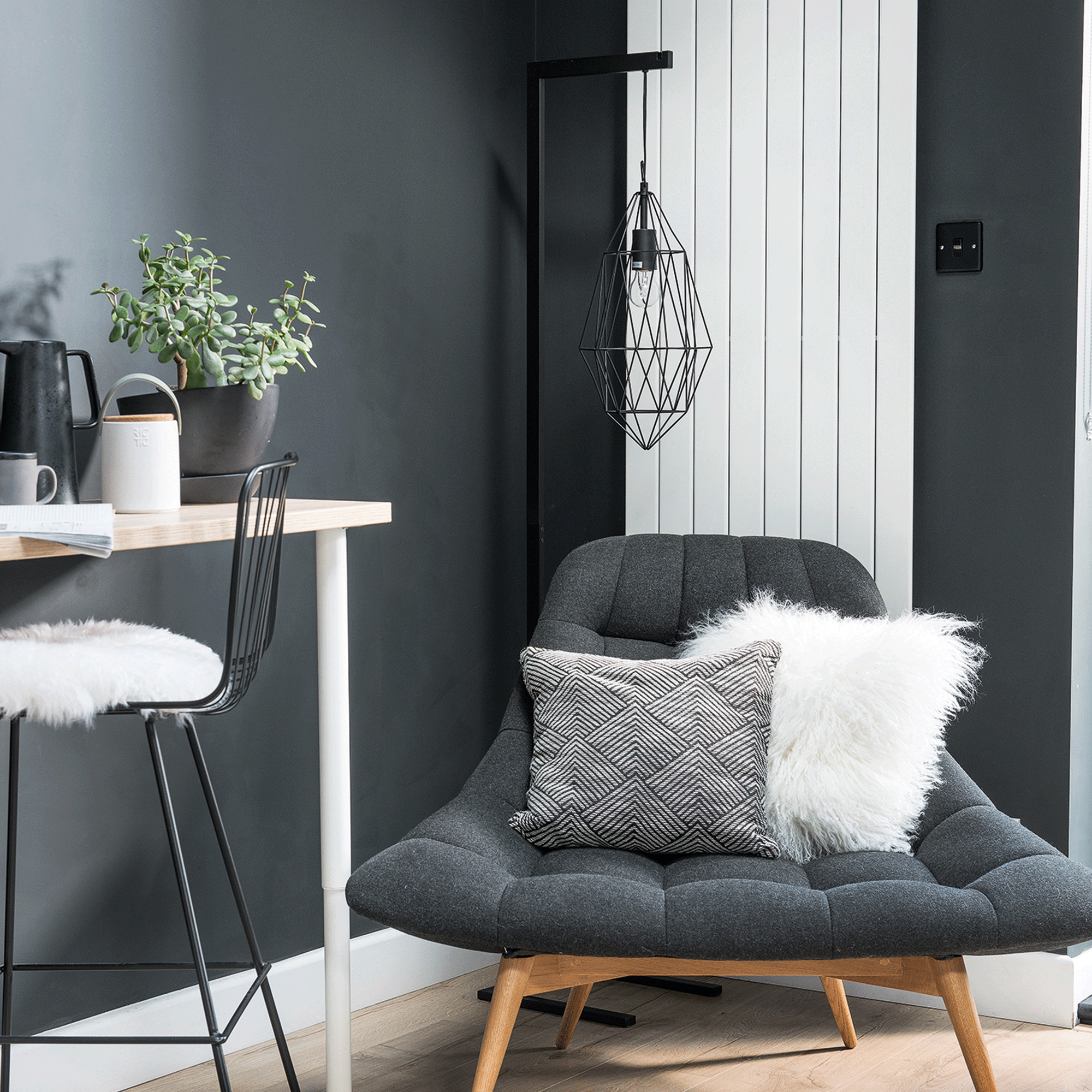 Grey chair in grey room with white radiator