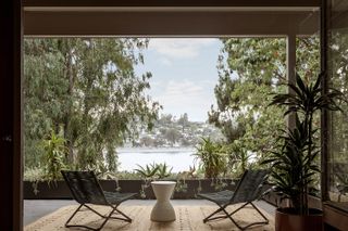 terrace with green views and water at Richard Neutra's Silver Lake Tree House