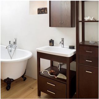 bathroom with wooden cabinets and bathtub