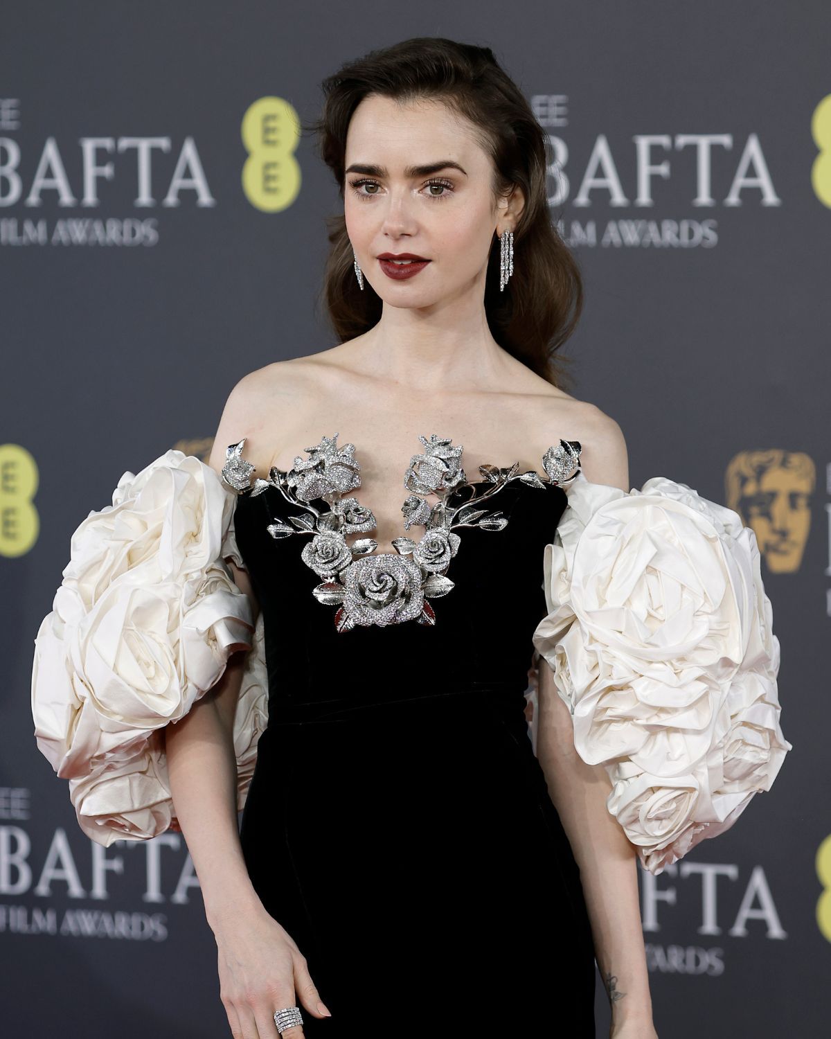Beauty News: This Easy Trick Is the Key to Expensive-Looking Hair—I Saw It All Over the BAFTAs 3 Lily Collins wearing a side parting at the BAFTAs 2024