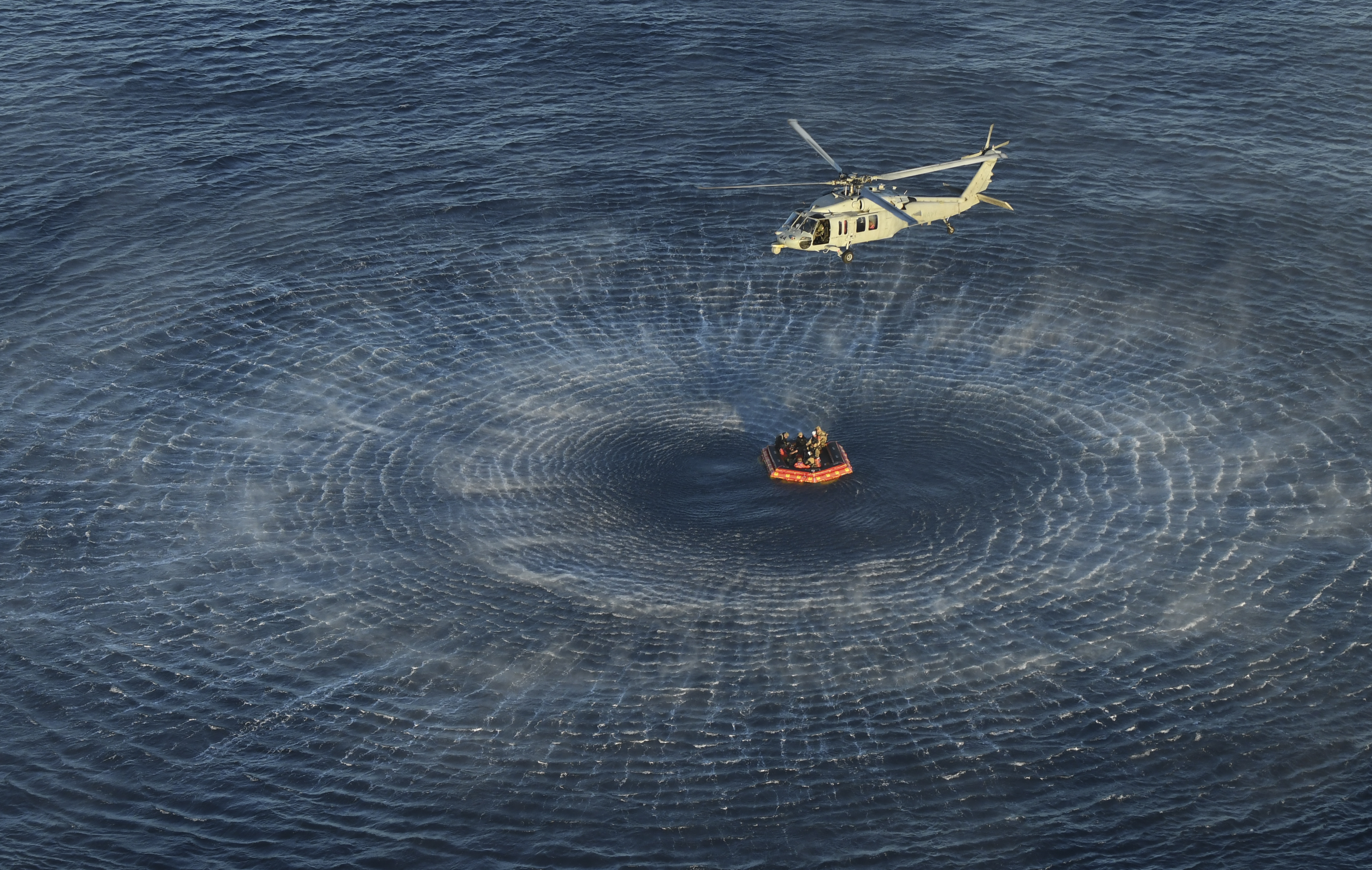 NASA Artemis II crew members are hoisted into a U.S. Navy MH-60 helicopter