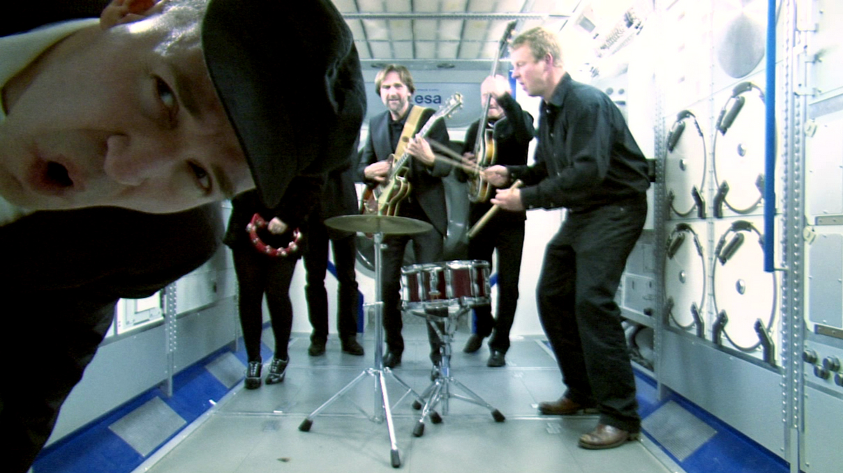 A still from the music video &quot;Back at the ISS&quot; by the Beatles tribute band Love &amp; Mersey.