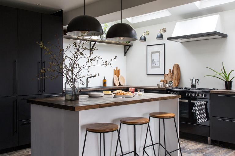 Quartz Countertop And Two Pendant Lights Over The Kitchen Island kitchens on a budget monochrome kitchen with wooden floors wooden worktops and a breakfast