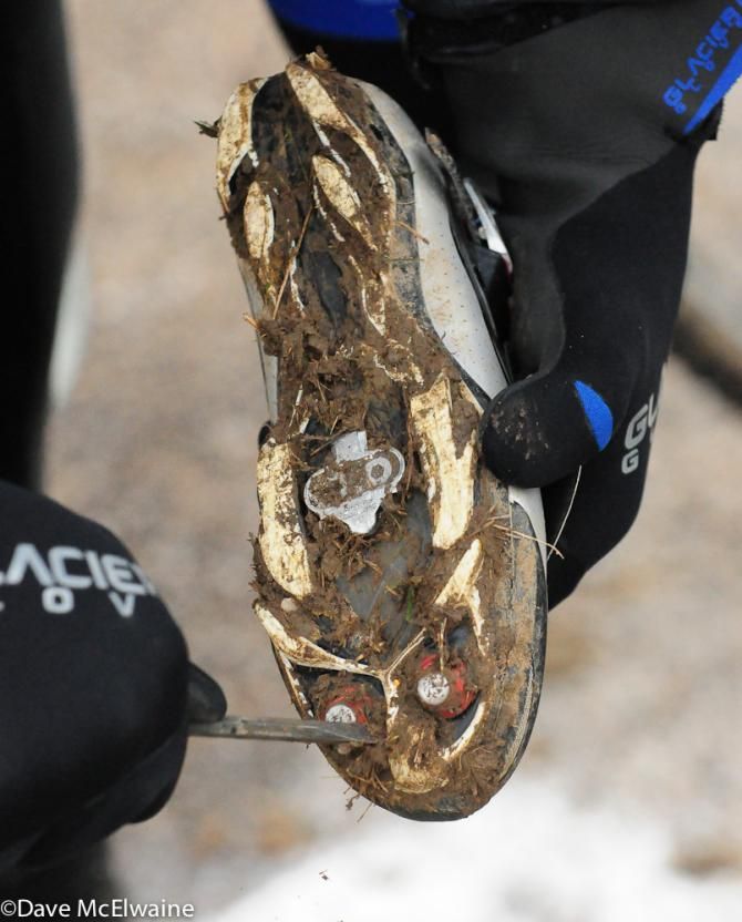 Katerina Nash has the mud cleared from her shoes at the starting line