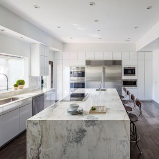 White modern kitchen with a marble island