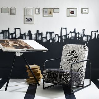 room with black and white flooring and wall with chair