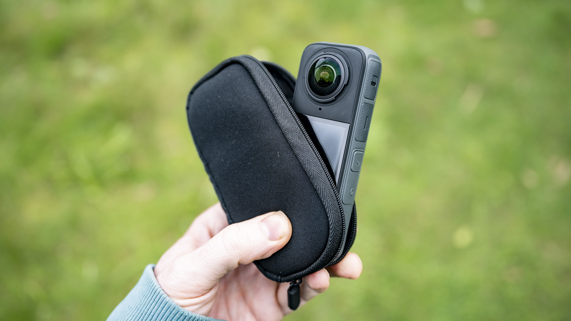 Insta360 X4 360 degree camera emerging from the supplied soft case