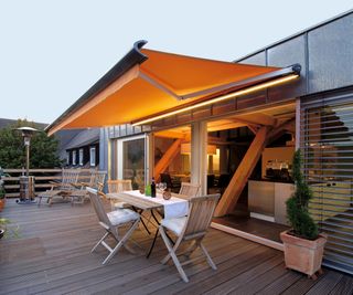 awning with built-in LED lights on a decked balcony