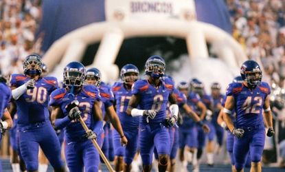 The Boise State Broncos run onto the field in 2009: Smaller schools like Boise State will likely get passed over in the new college football playoff system.