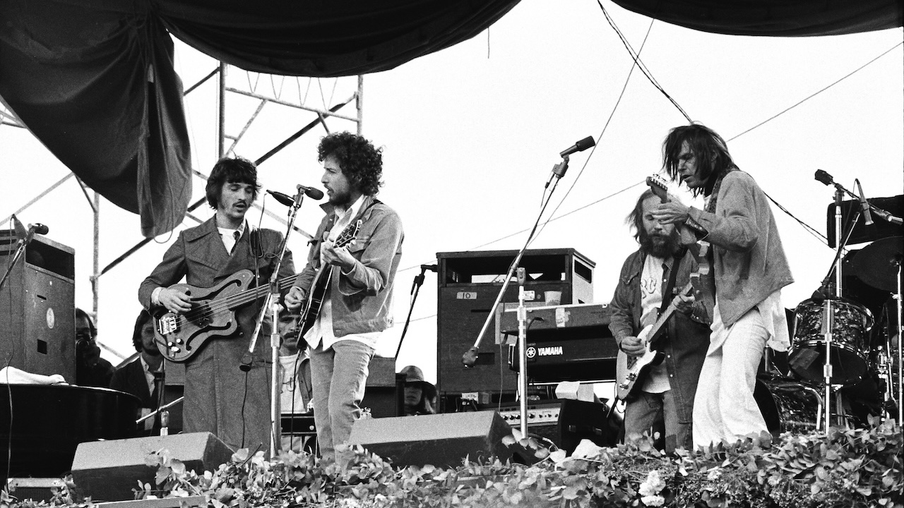 Rick Danko of The Band, Bob Dylan, unknown guitarist and Neil Young perform live in 1975.
