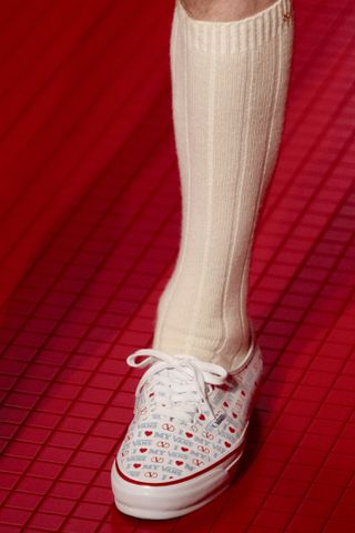 a model walks the valentino runway wearing vans sneakers from the vans valentino collaboration