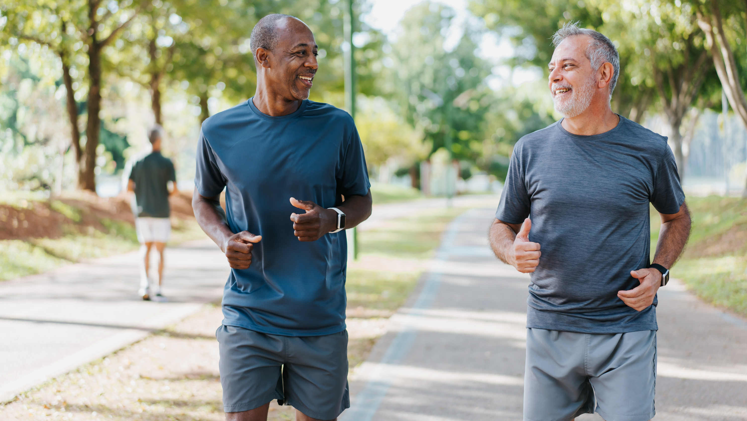 two men walking together in a park