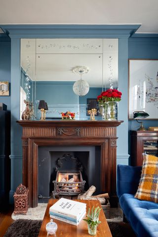 blue living room with fireplace and flowers