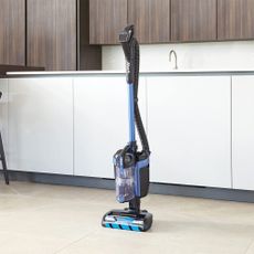 Shark vacuum cleaner in front of beige kitchen units