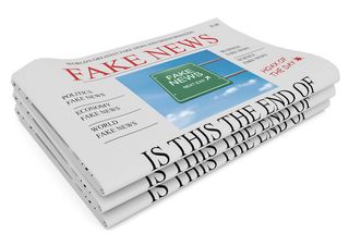 A newspaper has a headline reading "Fake News."