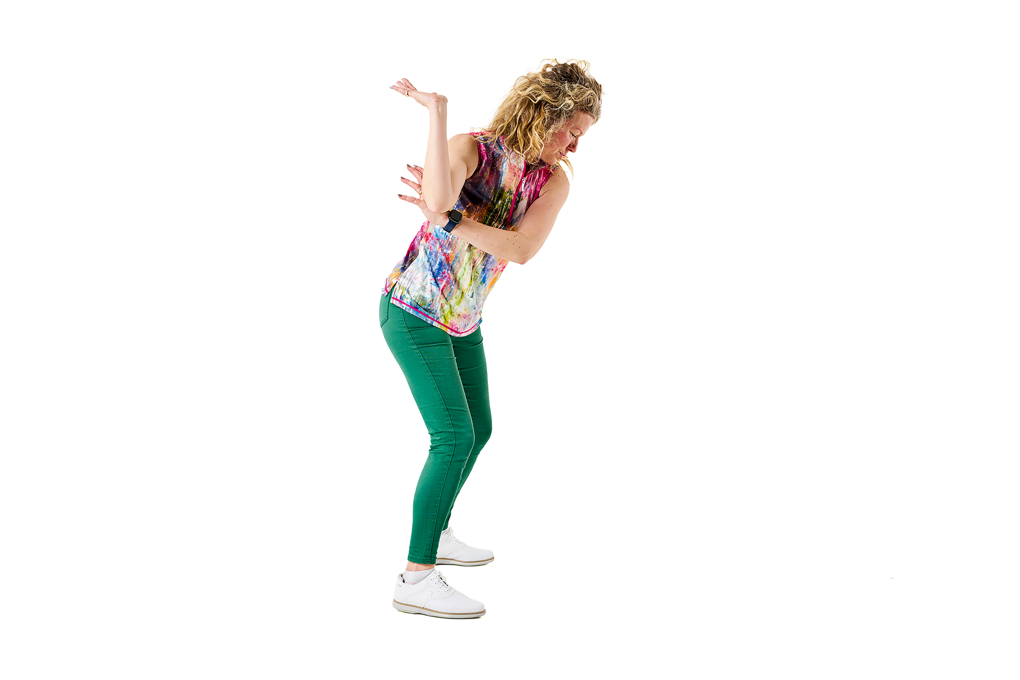 Katie Dawkins demonstrating a drill to fix the flying elbow, with her lead hand in a position similar to a waiter holding a tray of drinks