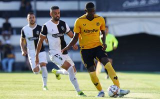 Yerson Mosquera of Wolverhampton Wanderers FC with Marco Matias of SC Farense in action during the Pre-Season Friendly match between SC Farense and Wolverhampton Wanderers at Estadio Sao Luis on July 31, 2022 in Faro, Portugal.
